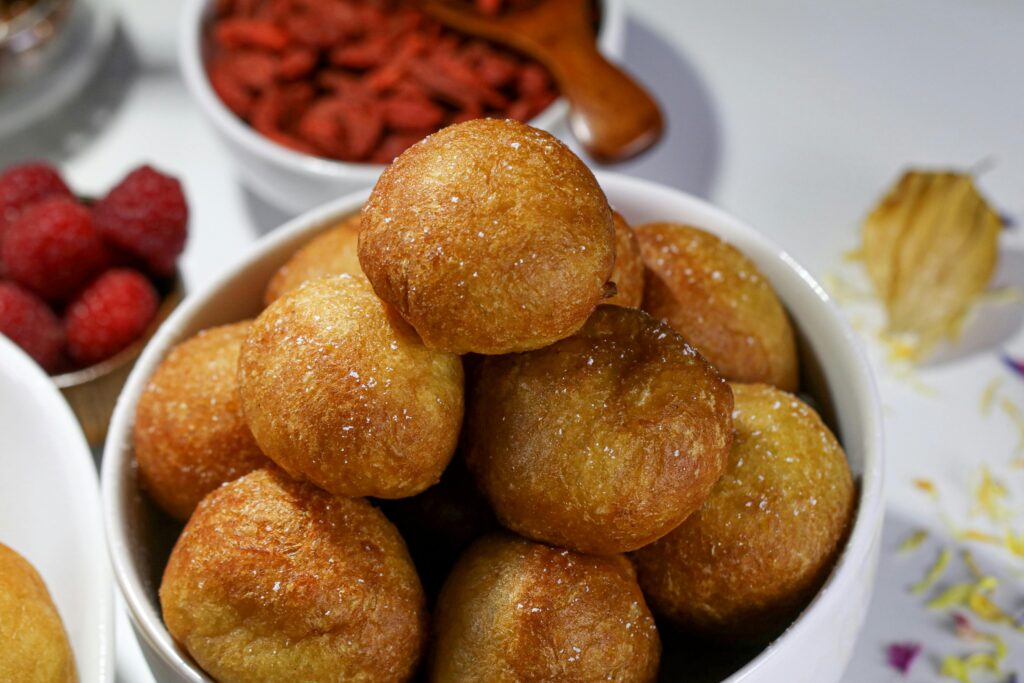 Puff-Puff (Nigerian Fried Dough Balls) Mouthwatering Nigerian puff puff in a white ceramic bowl, ready to eat.
